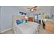 Bedroom with queen bed, dresser, and access to patio at 102 Cambridge Trl # 225, Sun City Center, FL 33573