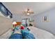 Bedroom with queen bed, dresser, and access to patio at 102 Cambridge Trl # 225, Sun City Center, FL 33573