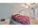 King-size bed, dresser, and ceiling fan in bedroom at 102 Cambridge Trl # 225, Sun City Center, FL 33573