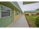 Exterior view of building with walkway and landscaping at 102 Cambridge Trl # 225, Sun City Center, FL 33573
