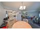 Kitchen and living room view, dining table with four chairs at 102 Cambridge Trl # 225, Sun City Center, FL 33573