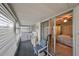 Enclosed patio with washer/dryer, chair, and view of bedroom at 102 Cambridge Trl # 225, Sun City Center, FL 33573
