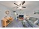 Living room with sofa, TV, and coffee table at 102 Cambridge Trl # 225, Sun City Center, FL 33573