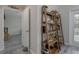 Hallway with wooden shelves and view into a room at 109 Peterson Ln, Palm Harbor, FL 34683