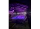 Lighted pool at night with comfortable seating at 109 Peterson Ln, Palm Harbor, FL 34683