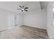 Spacious bedroom with ceiling fan and wood-look floors at 10904 Highview Dr, Dade City, FL 33525