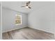 Bright bedroom with wood-look floors and ceiling fan at 10904 Highview Dr, Dade City, FL 33525