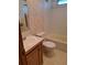 Clean bathroom with tub, toilet, sink, and floral wallpaper at 1463 Bobolink St, Zephyrhills, FL 33540