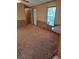 Spacious living room with neutral carpeting and wood paneling at 1463 Bobolink St, Zephyrhills, FL 33540