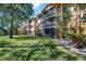 Condo building with balconies and landscaping at 1550 S Belcher Rd # 117, Clearwater, FL 33764