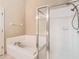 Bathroom with a large garden tub and walk-in shower at 15505 Granby Pl, Tampa, FL 33624