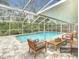 Relaxing pool area with covered patio and comfortable seating at 15505 Granby Pl, Tampa, FL 33624