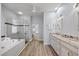 Modern bathroom with granite vanity, soaking tub, and glass shower at 1613 Sand Key Estates Ct, Clearwater, FL 33767