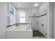 Spa-like bathroom with soaking tub, glass shower, and granite vanity at 1613 Sand Key Estates Ct, Clearwater, FL 33767