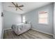Bedroom with ceiling fan and light wood flooring at 1613 Sand Key Estates Ct, Clearwater, FL 33767