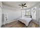 Bedroom with wood-look floors and bay window with shutters at 1613 Sand Key Estates Ct, Clearwater, FL 33767