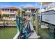 Private boat dock with walkway leading to waterfront home at 1613 Sand Key Estates Ct, Clearwater, FL 33767