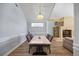 Dining area with a marble-top table and four chairs near a stone fireplace at 1613 Sand Key Estates Ct, Clearwater, FL 33767