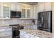 Modern kitchen featuring granite countertops and stainless steel appliances at 1613 Sand Key Estates Ct, Clearwater, FL 33767
