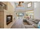 Living room with sectional sofa, stone fireplace, and access to a balcony at 1613 Sand Key Estates Ct, Clearwater, FL 33767
