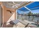 Waterfront patio with table and chairs at 1613 Sand Key Estates Ct, Clearwater, FL 33767