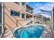 Inviting pool area with screened enclosure and spacious deck at 1613 Sand Key Estates Ct, Clearwater, FL 33767