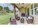 Relaxing covered patio with wicker furniture, perfect for outdoor entertaining at 18216 Beach Ranch Ter, Lakewood Ranch, FL 34211