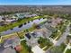 Community view showcasing homes with solar panels and a pond at 19354 Yellow Clover Dr, Tampa, FL 33647