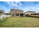 Large backyard, view of house, green grass at 19354 Yellow Clover Dr, Tampa, FL 33647