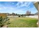 Large backyard with grassy area and white fence at 19354 Yellow Clover Dr, Tampa, FL 33647