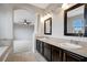 Double vanity bathroom with dark brown cabinets and large mirrors at 19354 Yellow Clover Dr, Tampa, FL 33647