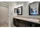Modern bathroom with double vanity, dark cabinets, and tiled floors at 19354 Yellow Clover Dr, Tampa, FL 33647