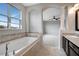Relaxing bathroom with a large soaking tub and view into the bedroom at 19354 Yellow Clover Dr, Tampa, FL 33647