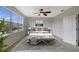 Bright bedroom featuring a comfortable bed, large windows, and ceiling fan at 19354 Yellow Clover Dr, Tampa, FL 33647