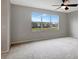 Spacious bedroom with large windows, ceiling fan, and neutral wall colors at 19354 Yellow Clover Dr, Tampa, FL 33647