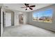 Spacious bedroom with large windows, ceiling fan, and ensuite bathroom at 19354 Yellow Clover Dr, Tampa, FL 33647
