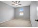 Simple bedroom with neutral walls, ceiling fan, and carpet at 19354 Yellow Clover Dr, Tampa, FL 33647