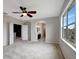 Spacious bedroom with large windows, ceiling fan, and neutral decor at 19354 Yellow Clover Dr, Tampa, FL 33647