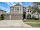 Two-story house with three-car garage, landscaping, and neutral color palette at 19354 Yellow Clover Dr, Tampa, FL 33647