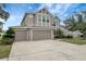 Two-story house with neutral siding, three-car garage, and landscaping at 19354 Yellow Clover Dr, Tampa, FL 33647