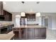 Kitchen boasts a large island, dark cabinetry and granite counters at 19354 Yellow Clover Dr, Tampa, FL 33647