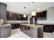Island kitchen with granite countertops and dark wood cabinets at 19354 Yellow Clover Dr, Tampa, FL 33647