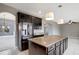 Large kitchen island with granite countertop offers extra prep space and seating at 19354 Yellow Clover Dr, Tampa, FL 33647