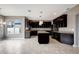 Modern kitchen featuring dark cabinetry, an island, and stainless steel appliances at 19354 Yellow Clover Dr, Tampa, FL 33647