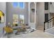 Living room with high ceilings, neutral walls, and staged furniture at 19354 Yellow Clover Dr, Tampa, FL 33647