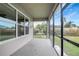 Screened patio with view of backyard and lush landscaping at 19354 Yellow Clover Dr, Tampa, FL 33647