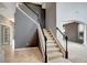 Elegant staircase with dark wood railing and carpeted steps at 19354 Yellow Clover Dr, Tampa, FL 33647