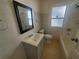 Bathroom with a vanity, toilet, bathtub, and window at 2035 11Th S St, St Petersburg, FL 33705