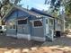 Side view of the house showcasing the blue exterior and landscaping at 2035 11Th S St, St Petersburg, FL 33705