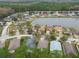 Community overview showing houses, a lake, and lush greenery at 25406 Lexington Oaks Blvd, Wesley Chapel, FL 33544